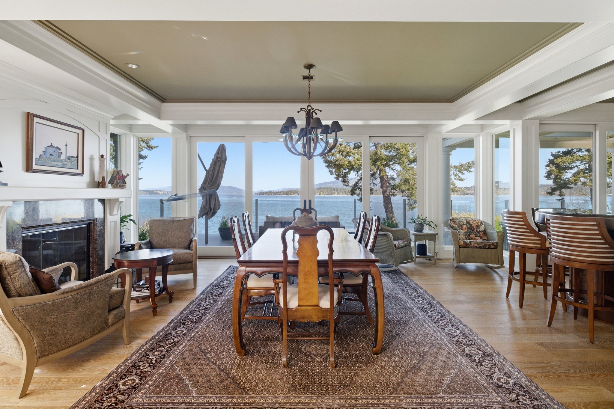 Formal dining room with panoramic ocean views through floor-to-ceiling windows