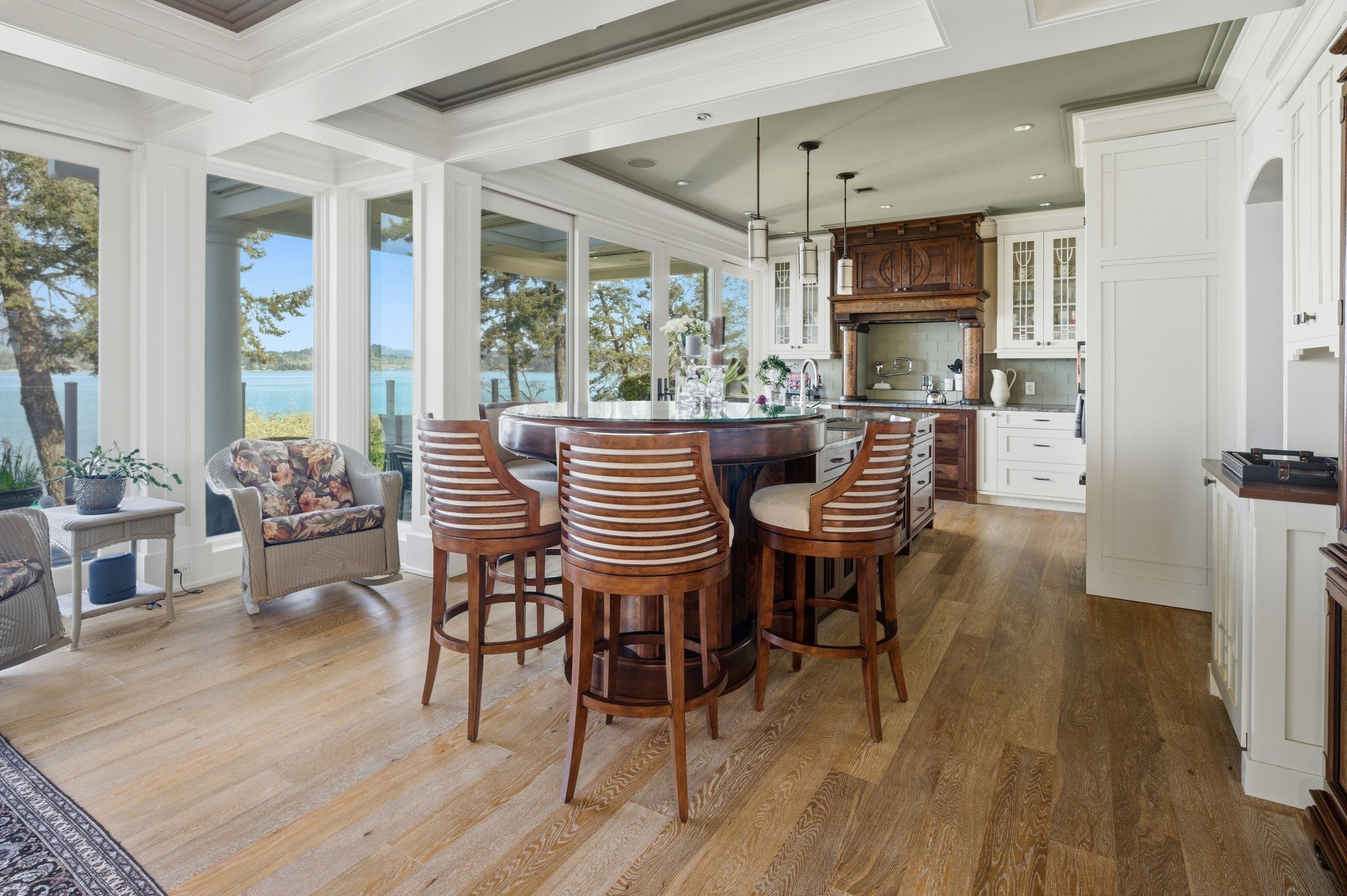 Custom kitchen with island, barstools, and Saanich Inlet views